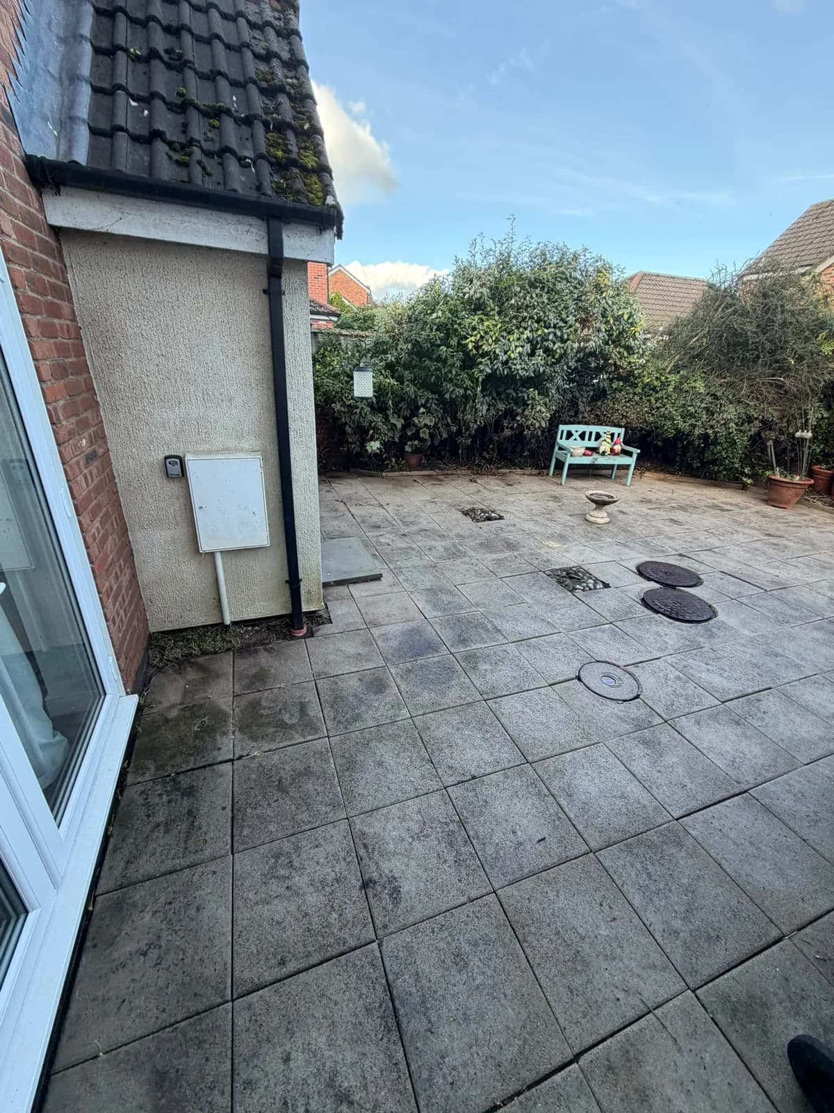 Patio beside the garden door after weeding and cleaning with the slab pattern exposed